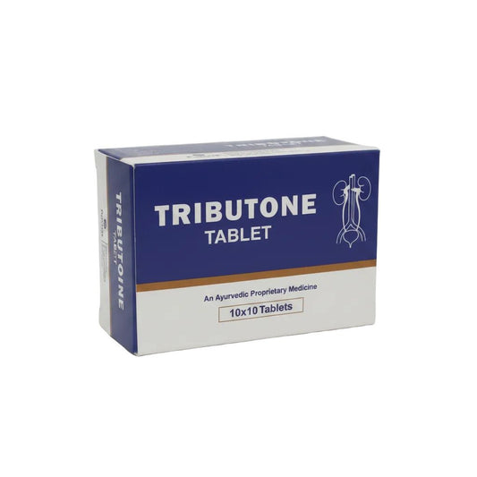 A box of Tributone Tablet, an Ayurvedic proprietary medicine, shown on a plain white background. The packaging is primarily dark blue and white with a thin brown stripe separating them.